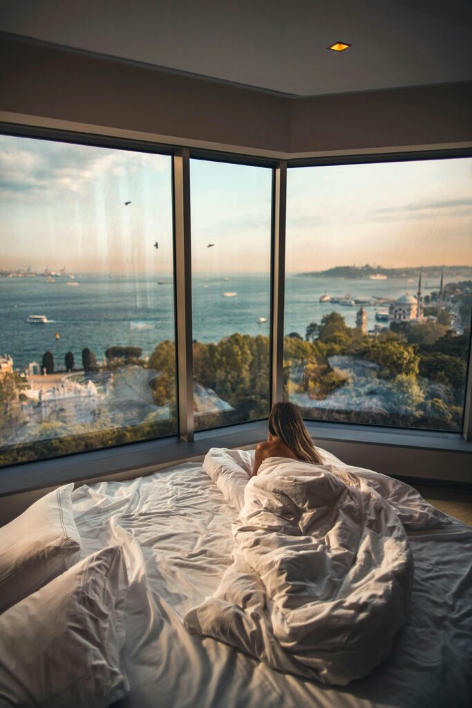 pexels-photo-2417842-2417842 Relaxing in a cozy hotel room with stunning views of the Bosphorus at sunset in Istanbul, Turkey.